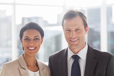 simsearch:400-06879270,k - Smiling colleagues in office standing together Stock Photo - Budget Royalty-Free & Subscription, Code: 400-06879264