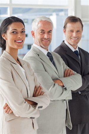 simsearch:400-06879270,k - Three smiling business people standing together with their arms folded Stock Photo - Budget Royalty-Free & Subscription, Code: 400-06879284