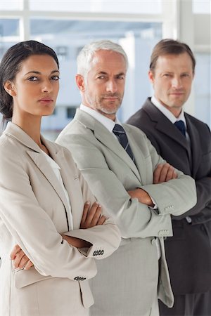 simsearch:400-06879270,k - Three serious business people standing together with their arms crossed Stock Photo - Budget Royalty-Free & Subscription, Code: 400-06879283