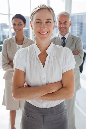 simsearch:400-06879270,k - Cheerful team of business people standing together with their arms crossed Stock Photo - Budget Royalty-Free & Subscription, Code: 400-06879293
