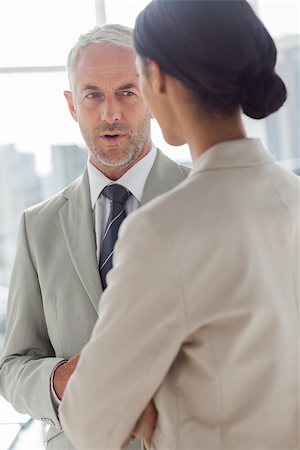 simsearch:400-06879270,k - Concentrated businessman listening to female colleague in the office Stock Photo - Budget Royalty-Free & Subscription, Code: 400-06879306