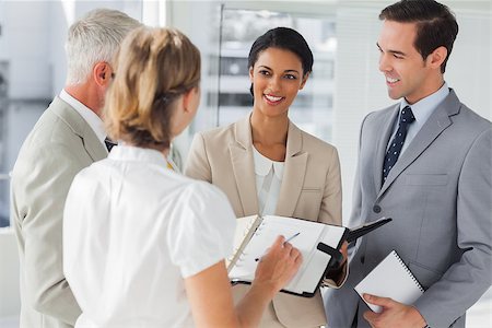 simsearch:400-06879270,k - Smiling business people making an appointment in the workplace Stock Photo - Budget Royalty-Free & Subscription, Code: 400-06879308