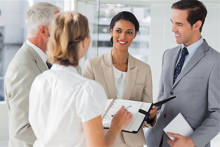 simsearch:400-06879270,k - Cheerful business people making an appointment in the office Stock Photo - Budget Royalty-Free & Subscription, Code: 400-06879309
