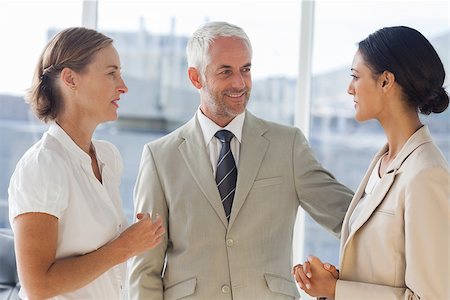 simsearch:400-06879270,k - Likeable businessman speaking with female colleagues during working hours Stock Photo - Budget Royalty-Free & Subscription, Code: 400-06879300
