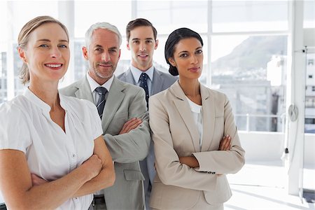 simsearch:400-06879270,k - Smiling business people standing together with their arms crossed Stock Photo - Budget Royalty-Free & Subscription, Code: 400-06879322