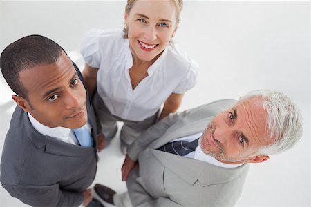 simsearch:400-06879270,k - Overview of three business people standing close to each other in the workplace Stock Photo - Budget Royalty-Free & Subscription, Code: 400-06879337
