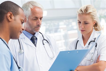 examination folder - Doctors examining a file together at the office Stock Photo - Budget Royalty-Free & Subscription, Code: 400-06879476