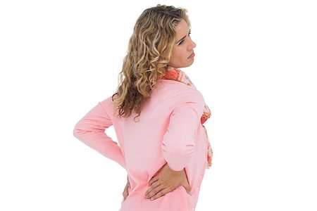 simsearch:400-06885115,k - Blonde girl having a back ache and holding her back on white background Photographie de stock - Aubaine LD & Abonnement, Code: 400-06879634