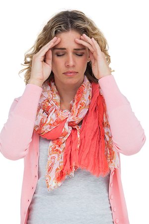 simsearch:400-06885115,k - Blonde girl touching her temples because of a headache on white background Photographie de stock - Aubaine LD & Abonnement, Code: 400-06879635