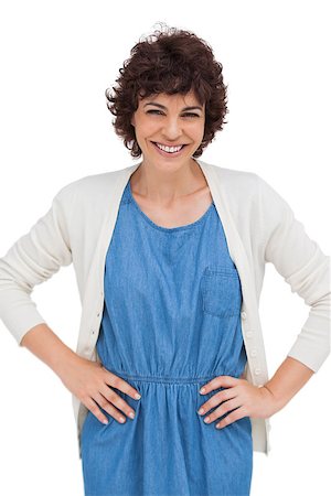 Smiling brunette woman placing hands on hips on white background Stock Photo - Budget Royalty-Free & Subscription, Code: 400-06879685