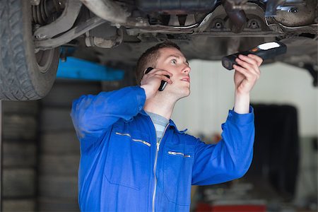 simsearch:400-06870137,k - Male mechanic on call while examining car Photographie de stock - Aubaine LD & Abonnement, Code: 400-06870081