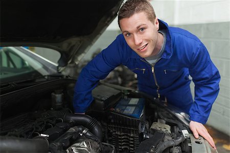 simsearch:400-06870097,k - Portrait of happy mechanic repairing under car hood Foto de stock - Super Valor sin royalties y Suscripción, Código: 400-06870101