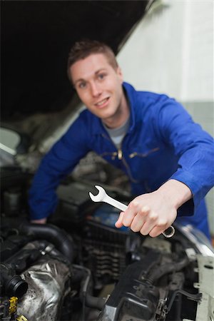 simsearch:400-06878892,k - Portrait of male mechanic with spanner repairing car Photographie de stock - Aubaine LD & Abonnement, Code: 400-06870103