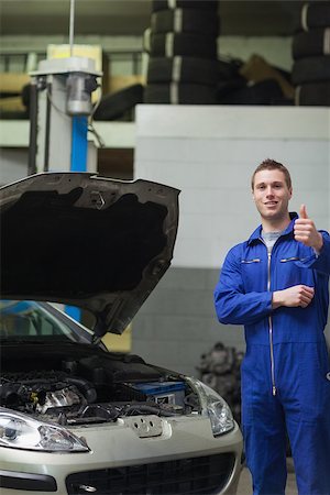 simsearch:400-06878892,k - Portrait of male mechanic by car with open hood gesturing thumbs up Photographie de stock - Aubaine LD & Abonnement, Code: 400-06870124