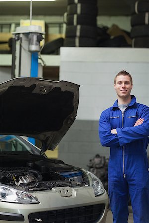 simsearch:400-06878892,k - Portrait of confident male mechanic standing by car with open hood Photographie de stock - Aubaine LD & Abonnement, Code: 400-06870123