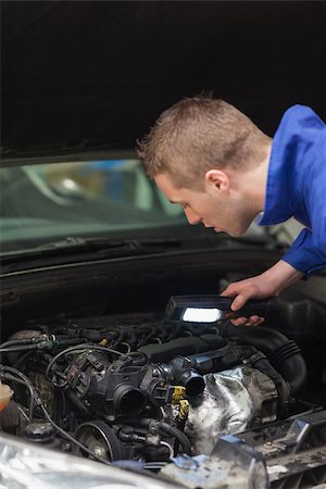 simsearch:400-06870131,k - Repairman with flashlight examining car engine Photographie de stock - Aubaine LD & Abonnement, Code: 400-06870136
