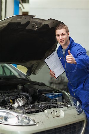 simsearch:400-06878892,k - Portrait of male mechanic by car with open hood showing thumbs up Photographie de stock - Aubaine LD & Abonnement, Code: 400-06870145