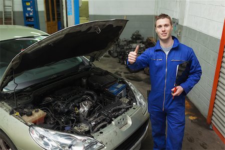 simsearch:400-06878892,k - Portrait of male mechanic by car gesturing thumbs up Photographie de stock - Aubaine LD & Abonnement, Code: 400-06870155