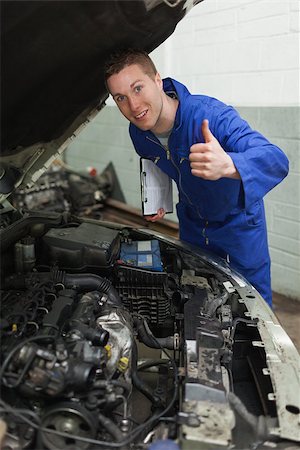 simsearch:400-06878892,k - Portrait of confident mechanic by car with open hood gesturing thumbs up Photographie de stock - Aubaine LD & Abonnement, Code: 400-06870151