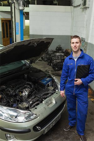 simsearch:400-06878892,k - Portrait of confident male mechanic standing by car with open hood Photographie de stock - Aubaine LD & Abonnement, Code: 400-06870153