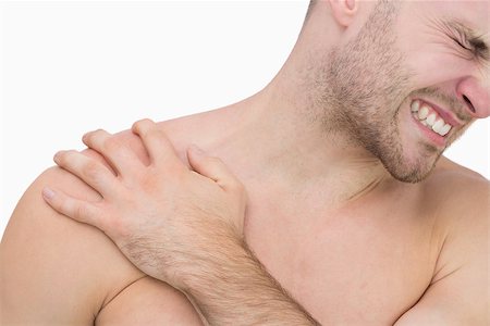 simsearch:6109-06684724,k - Closeup of young shirtless man with shoulder pain over white background Stock Photo - Budget Royalty-Free & Subscription, Code: 400-06870348
