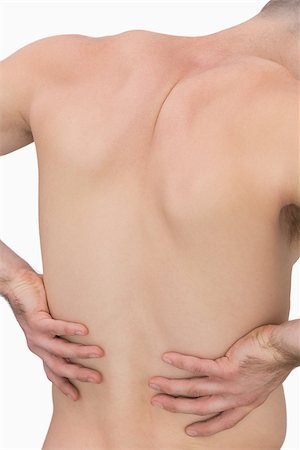 Rear view of muscular man with backache over white background Photographie de stock - Aubaine LD & Abonnement, Code: 400-06870342