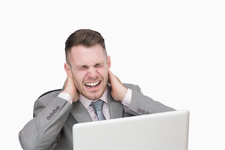 Business man suffering from severe neck pain while using laptop over white background Stock Photo - Budget Royalty-Free & Subscription, Code: 400-06870367