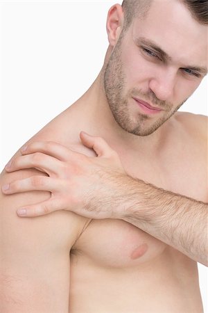 simsearch:6109-06684724,k - Closeup of shirtless man with shoulder pain over white background Stock Photo - Budget Royalty-Free & Subscription, Code: 400-06870362