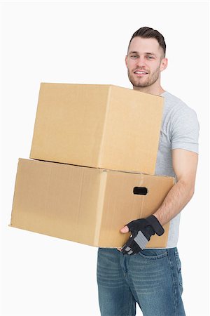 simsearch:693-06323979,k - Portrait of young man carrying package boxes over white background Stock Photo - Budget Royalty-Free & Subscription, Code: 400-06870408