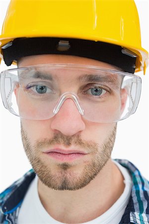 Closeup portrait of architect wearing protective eyewear and hardhat over white background Stock Photo - Budget Royalty-Free & Subscription, Code: 400-06870438