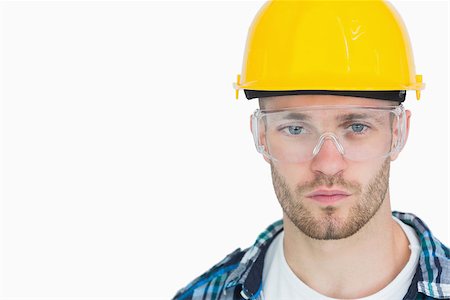 Closeup portrait of architect wearing protective eyewear and hardhat over white background Stock Photo - Budget Royalty-Free & Subscription, Code: 400-06870439