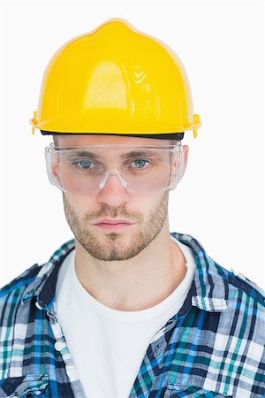 Closeup portrait of architect wearing protective eyewear and hardhat over white background Stock Photo - Budget Royalty-Free & Subscription, Code: 400-06870440