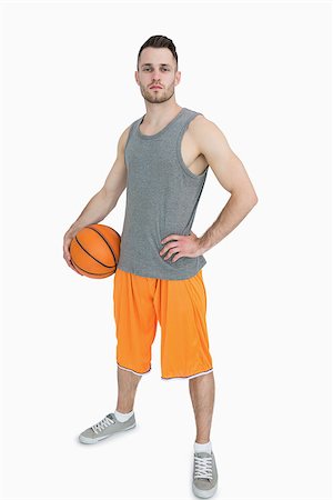 Portrait of young man with basketball standing over white background Stock Photo - Budget Royalty-Free & Subscription, Code: 400-06870464