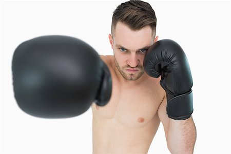 simsearch:400-06876600,k - Portrait of young male boxer punching over white background Stock Photo - Budget Royalty-Free & Subscription, Code: 400-06870463
