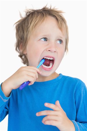 Young boy brushing his teeth over white background Stock Photo - Budget Royalty-Free & Subscription, Code: 400-06870548