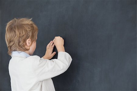 Rear view of young boy dressed as teacher and writes on black board Stock Photo - Budget Royalty-Free & Subscription, Code: 400-06870579