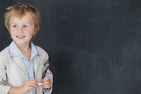 Happy young boy dressed as teacher standing in front of black board Stock Photo - Budget Royalty-Free & Subscription, Code: 400-06870594