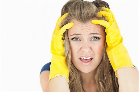 simsearch:400-06870646,k - Young upset chore woman wearing yellow cleaning gloves on an isolated white background Stock Photo - Budget Royalty-Free & Subscription, Code: 400-06870595