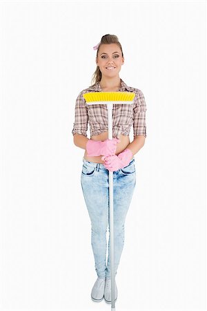 simsearch:400-06870642,k - Portrait of casual young woman holding broom over white background Stock Photo - Budget Royalty-Free & Subscription, Code: 400-06870608