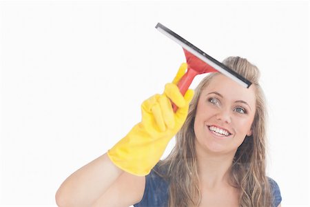 simsearch:400-06870642,k - Beautiful young maid in yellow gloves using wiper over white background Stock Photo - Budget Royalty-Free & Subscription, Code: 400-06870601