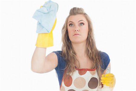 simsearch:400-06870646,k - Beautiful young maid using duster and disinfectant spray over white background Stock Photo - Budget Royalty-Free & Subscription, Code: 400-06870602