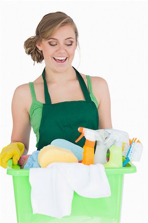 simsearch:400-06870642,k - Happy young maid carrying cleaning supplies over white background Stock Photo - Budget Royalty-Free & Subscription, Code: 400-06870625