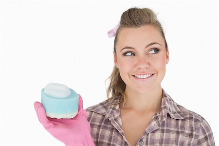 simsearch:400-06870646,k - Smiling woman holding soap suds over sponge against white background Stock Photo - Budget Royalty-Free & Subscription, Code: 400-06870622