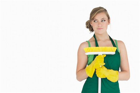 simsearch:400-06870646,k - Young woman standing with broom over white background Stock Photo - Budget Royalty-Free & Subscription, Code: 400-06870634