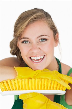 simsearch:400-06870642,k - Closeup portrait of cheerful young woman with broom over white background Stock Photo - Budget Royalty-Free & Subscription, Code: 400-06870630