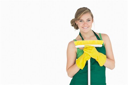 simsearch:400-06870646,k - Portrait of young woman with broom over white background Stock Photo - Budget Royalty-Free & Subscription, Code: 400-06870632