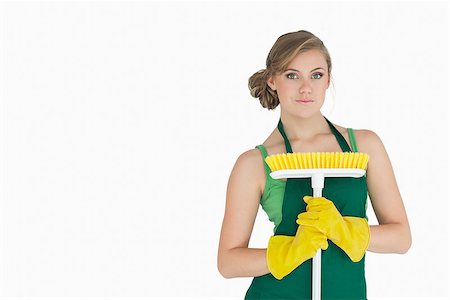 simsearch:400-06870646,k - Portrait of young woman with broom over white background Stock Photo - Budget Royalty-Free & Subscription, Code: 400-06870633