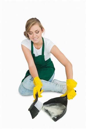 simsearch:400-06870642,k - Smiling young maid using brush and dust pan over white background Stock Photo - Budget Royalty-Free & Subscription, Code: 400-06870644