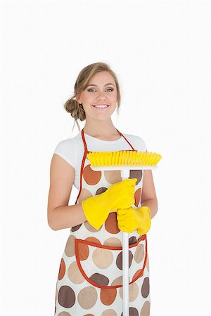 simsearch:400-06870646,k - Portrait of smiling young woman with broom over white background Stock Photo - Budget Royalty-Free & Subscription, Code: 400-06870658