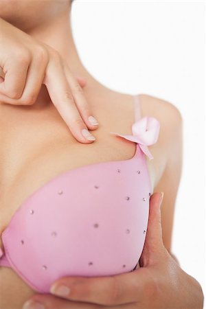 simsearch:400-06870717,k - Extreme closeup of woman performing self breast examination over white background Stock Photo - Budget Royalty-Free & Subscription, Code: 400-06870715